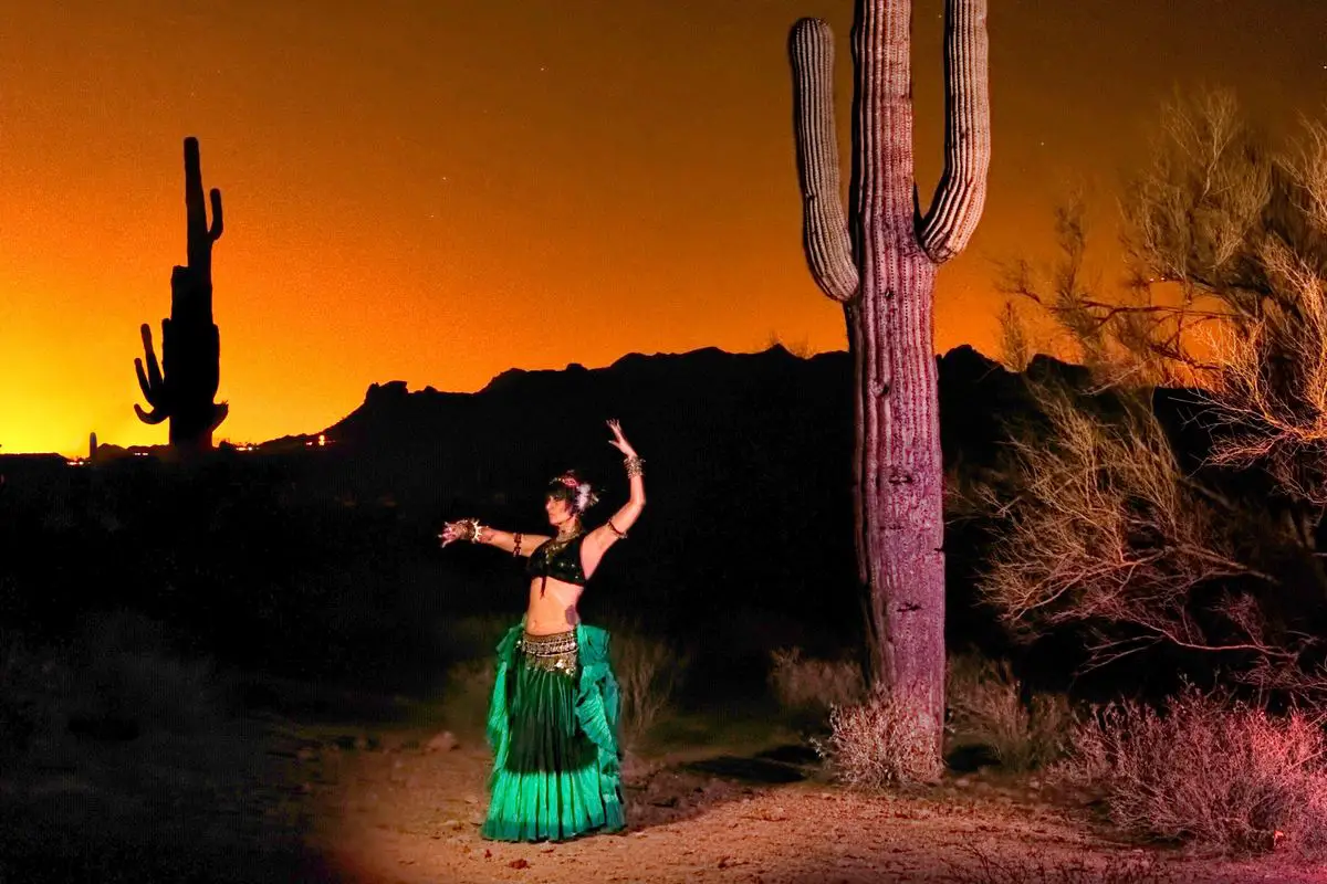 a woman in a green dress and a cactus in the desert. Free Camping in Tucson Arizona